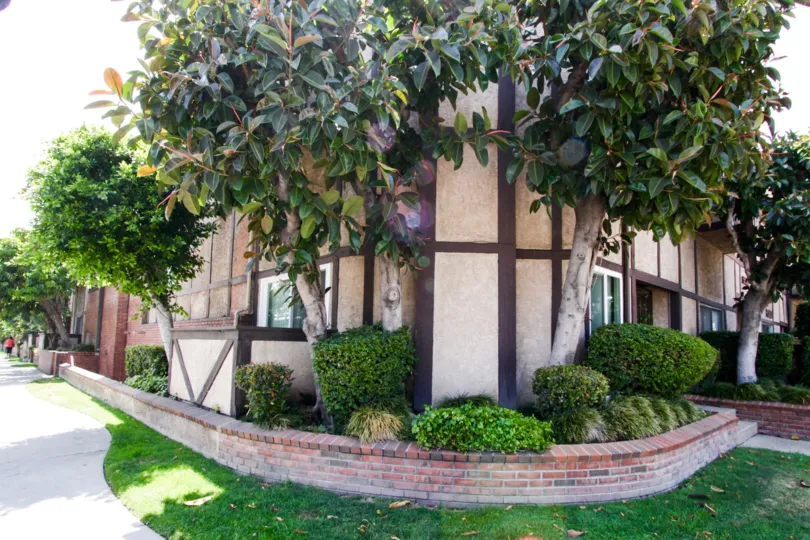 The corner of Encino Park Plaza complete with landscaped trees and brick edging