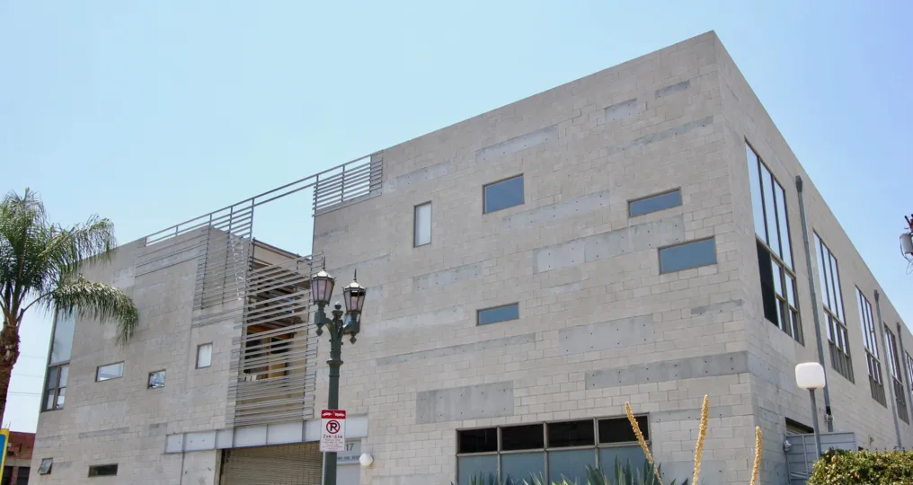 The Cahuenga Lofts with large windows and a tree in its front side