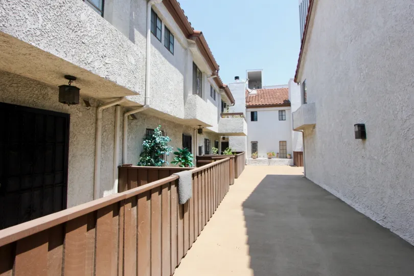Alley way at the Chateau Marmont. Several apartments behind a wooden wall