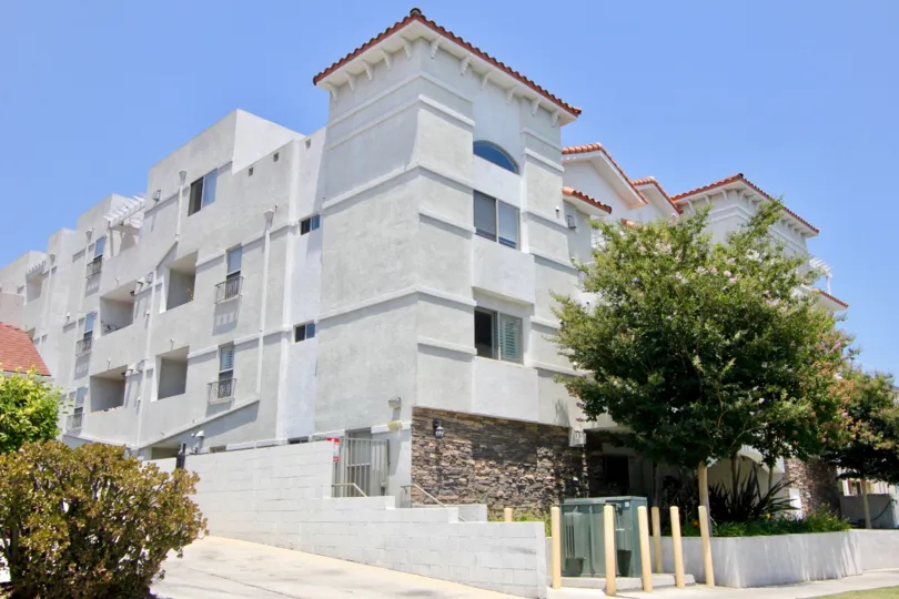 Side view of Elmwood Villa with stone siding and trees