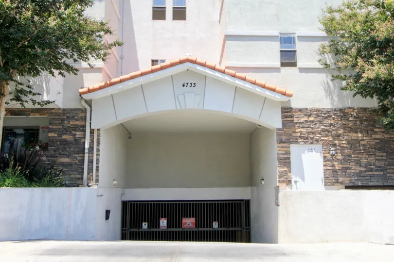 Garage entrance at Elmwood VIlla. Nice vaulted entrance with stone siding and trees