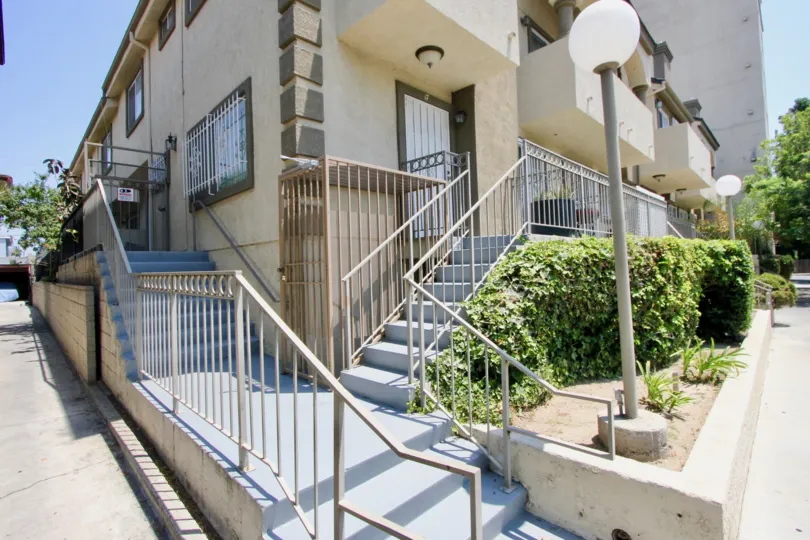 The stairway, lined by shubbery and post lighting, of the Gramercy Place Townhomes in Hancock Park California.