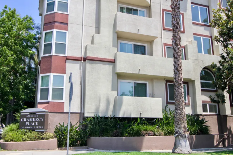 A APARTMENT WITH THREE FLOORS AND GLASS WINDOW SOME TREES ALSO NEAR TO THE PLACE AT THE MORNING TIME