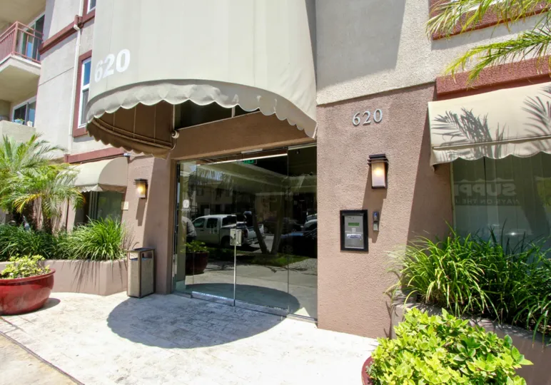 The eye-catching semicircular awning of the entrance with glass doors at 620 Gramercy Place