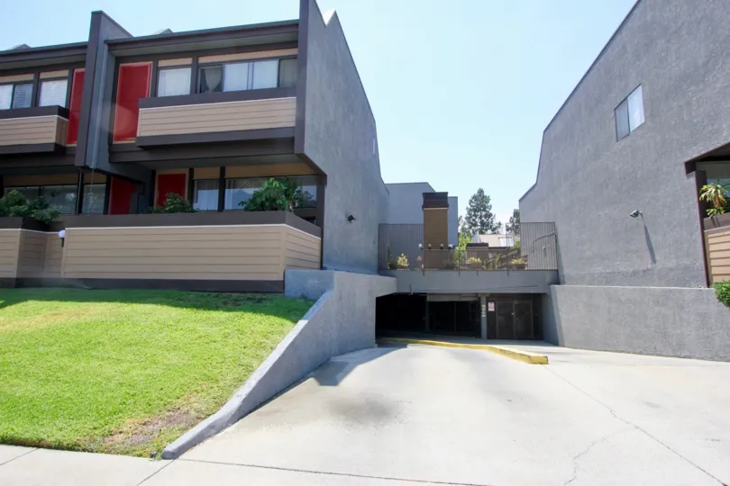 Parking entrance at Hancock Park square with manicured lawn and personal terraces.