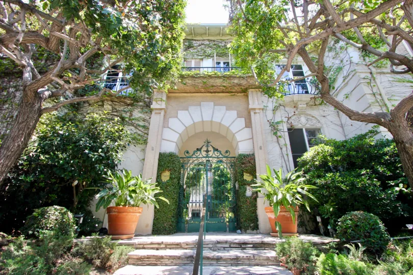 A stunning entrance and mature trees at Il Borghese community, Hancock park.