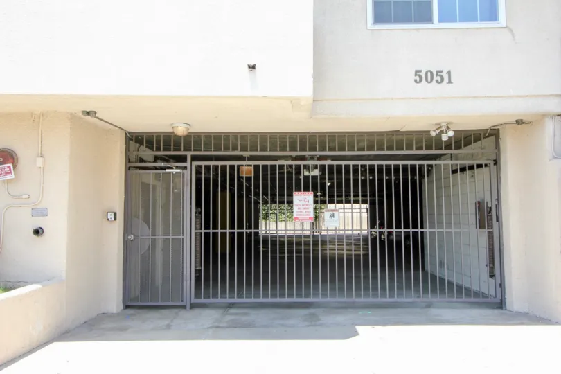 Entrance to an underground parking lot with light gray grilles