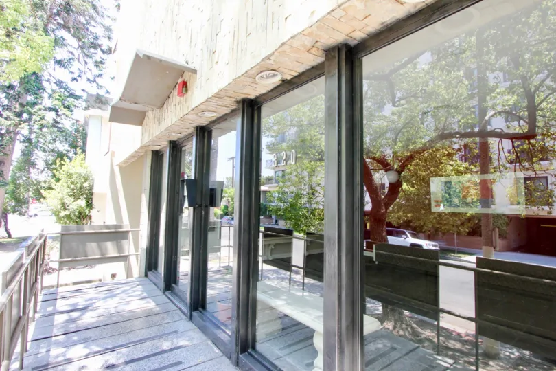Beautiful day at The Essex House looking at the front porch with large glass windows