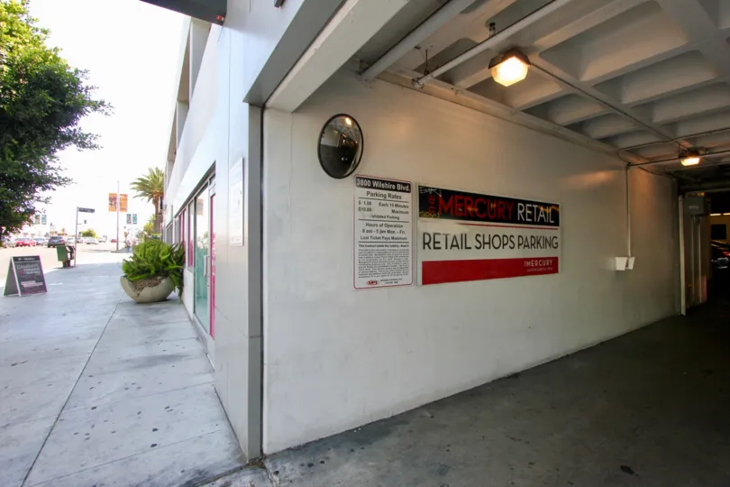 A shady sidewalk and parking entrance at The Mercury.