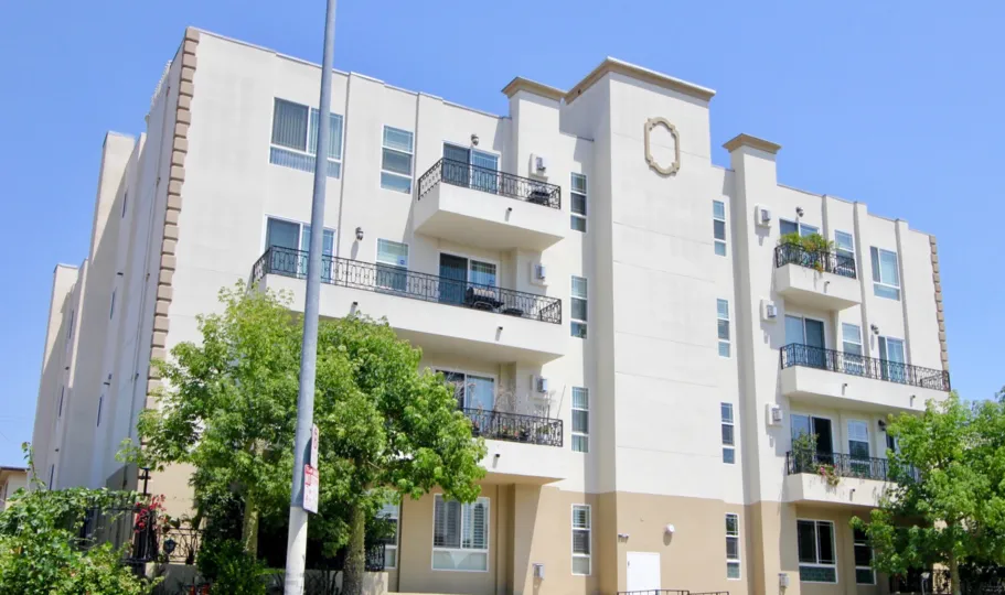 The Wilton Villas with white color and with many glass windows and trees in front side