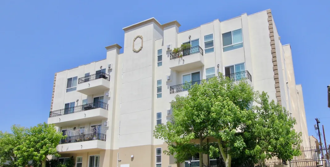A beautiful sky high well construct building which have elegant colour and shiny bright glass windows. Lots of green trees enhance its beauty. A sunny bright day give it an amazing look.