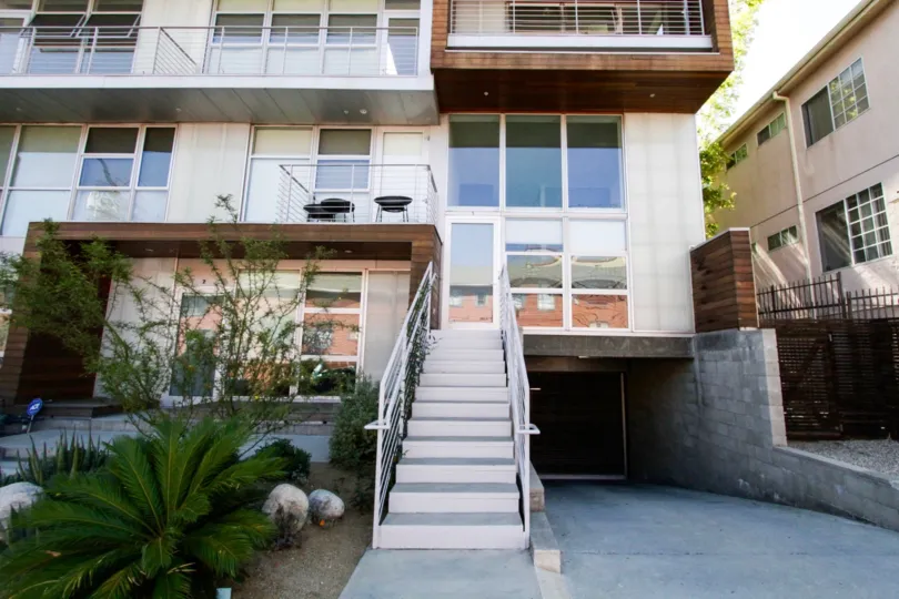 Metal and concrete stairs lead to the entrance of this unit at 611 N Bronson