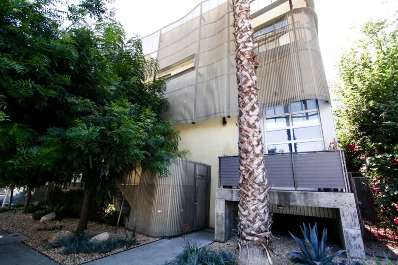 Gordon Lofts is a square stucco building wrapped by free flowing metal accents
