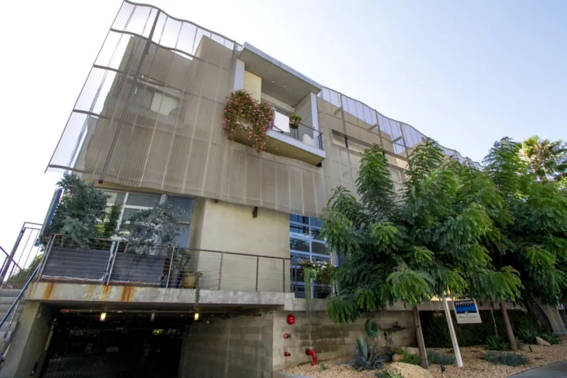 A large planter landscaped with trees and bushes greats Gordon Lofts residents