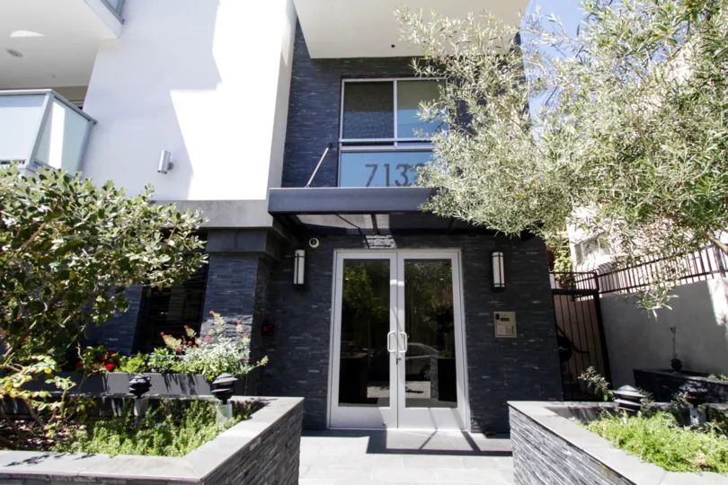 Stacked slate stone wraps the raised planters and accents the front entrance to Hawthorn in Hollywood