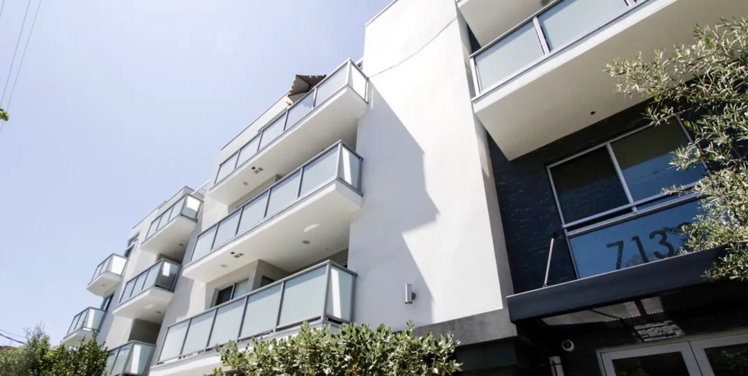 A modern flair embodies Hawthorn in Hollywood with white stucco, glass balconies and stacked stone