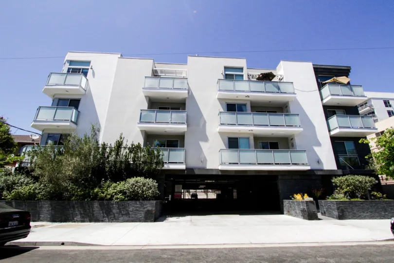 Hawthorn in Hollywood is a beautiful white stucco building with glass and stone accents