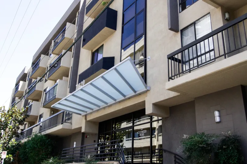A frosted glass and metal awning cover the Hollywood Regis entry
