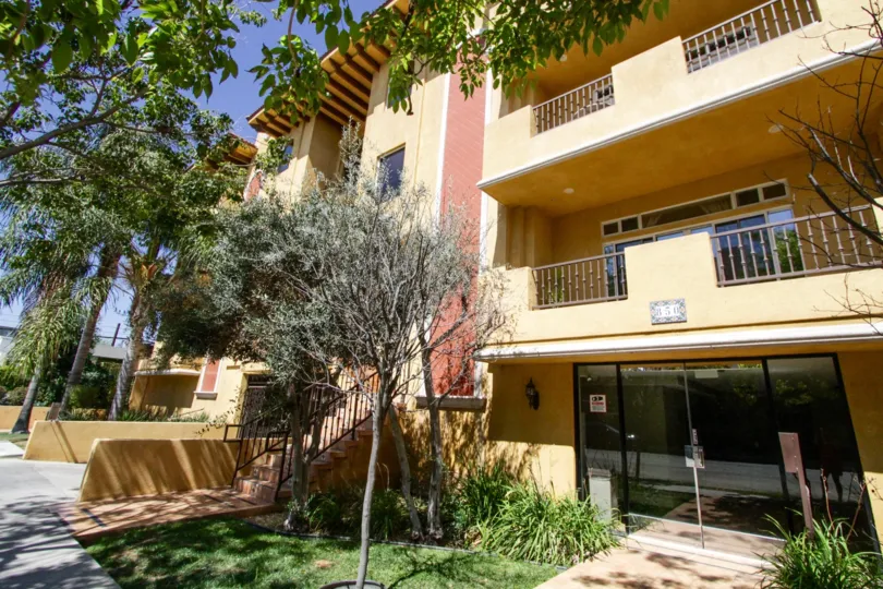 Bright tan stucco and red tiles accents compose the Il Villagio building