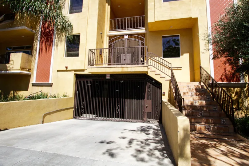 Terracotta laid stairs leads to the wrought iron gated entrance of Il Villagio