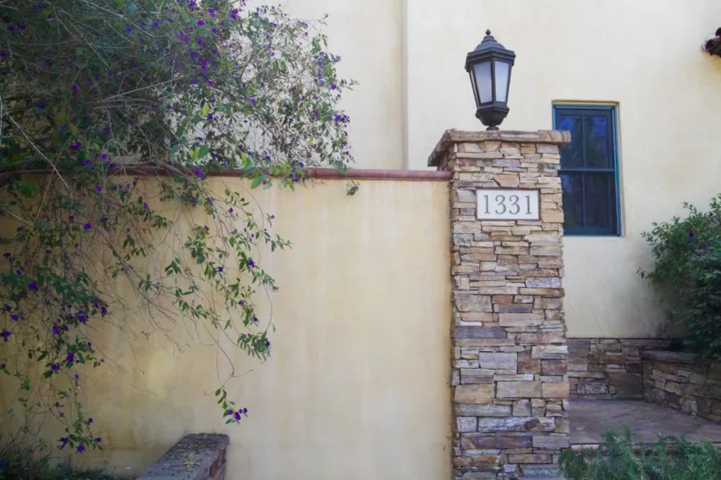 Address numbers on a stacked stone pillar near the entry to La Serenata