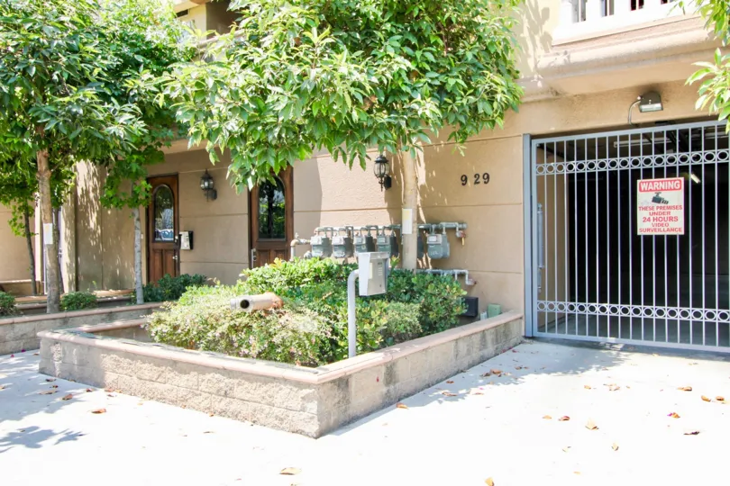 A bright day in the Arena Cove Villas with a gate front and sign board.