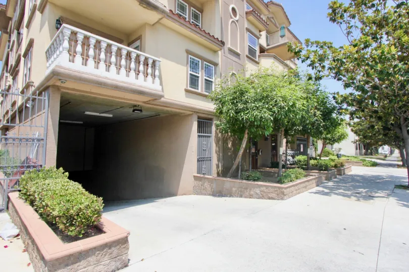The garage entrance and an upper balcony in the Arena Cove Villas in Koreatown, California