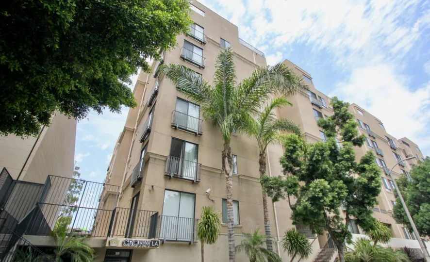 Brown walls, Clear Skies and Green trees around the Barcelona Tower, Koreatown, California