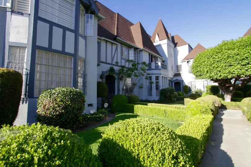 Lush gardens lead to the entry of Chateau Alpine