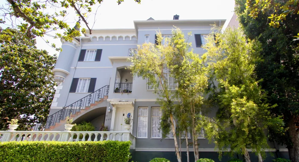 Purple walls and green trees of French Chateau, Koreatown, California