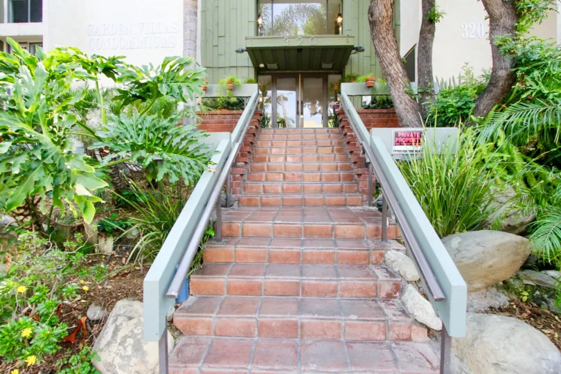 The brick stair of house in the Garden Villas with small bushes and shrubs