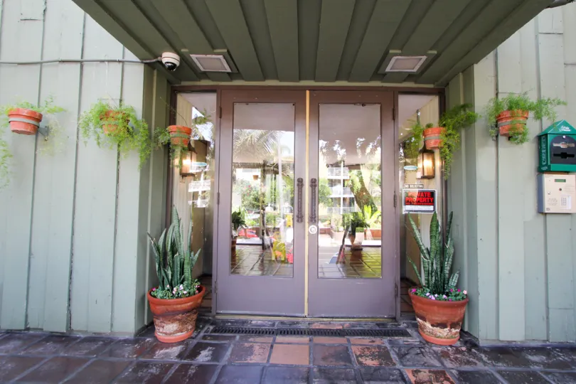 entrance decorated with plants in front of the door in building Garden Villas