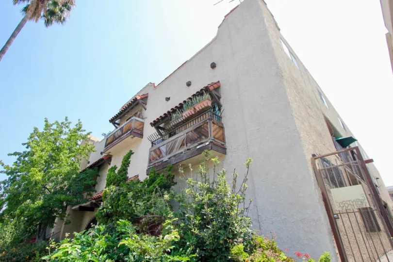 Side of a townhome at Hancock Townhomes with window and plants