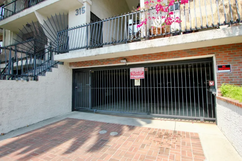 A sunny day at Harvard Gardens Apartments with stairs and parking garage