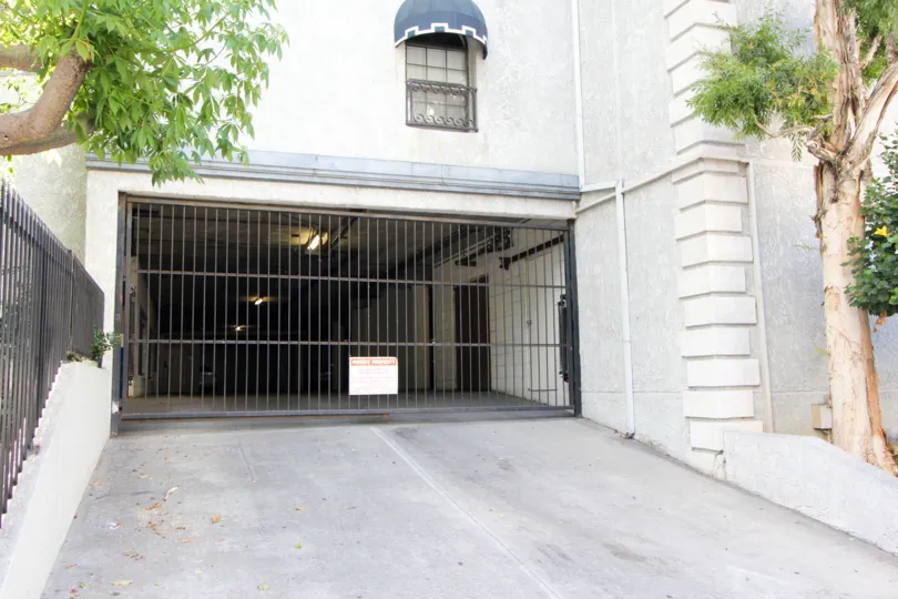 Daylight scene of the garage entrance to Kenmore Manor with gate down to prevent access.