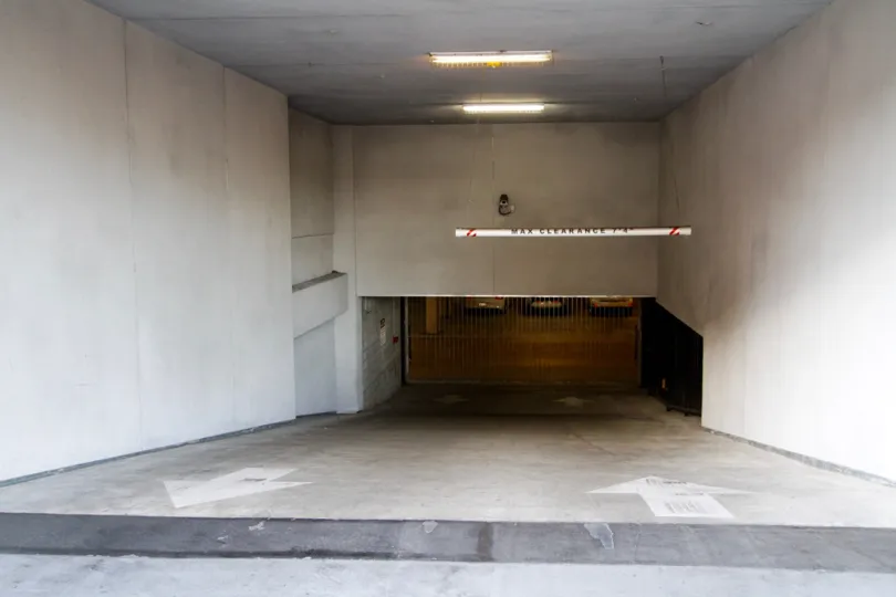 Down the driveway is the gated parking garage for Kenmore Tower