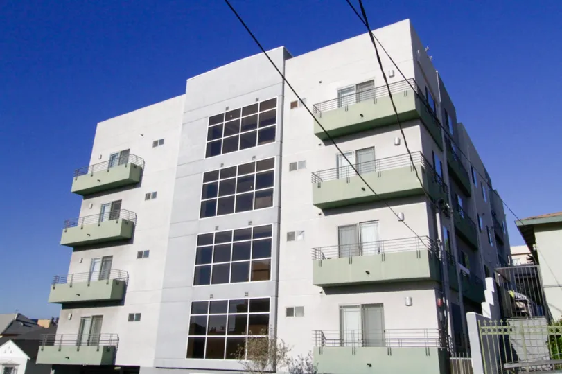 The Kingsley Manor building has balconies wrapping each side and walls of glass at its center
