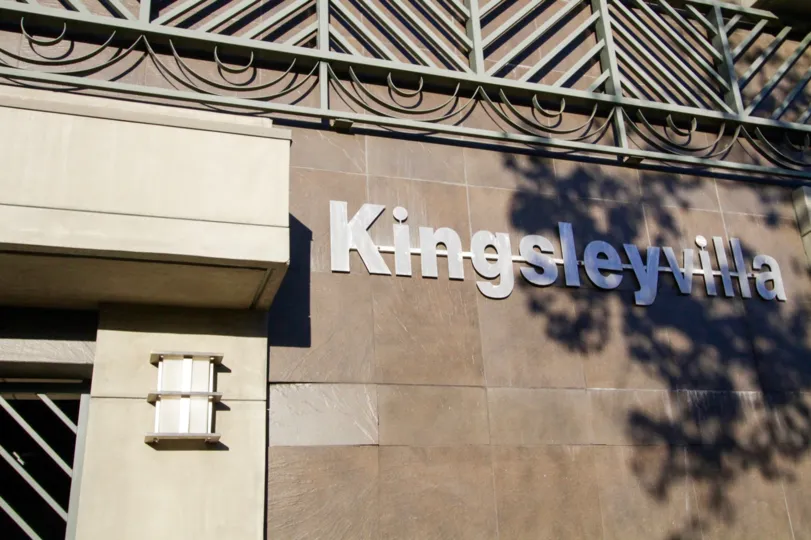 The Kingsley Villa building marquee is made of metal letters with a strikethrough in the background