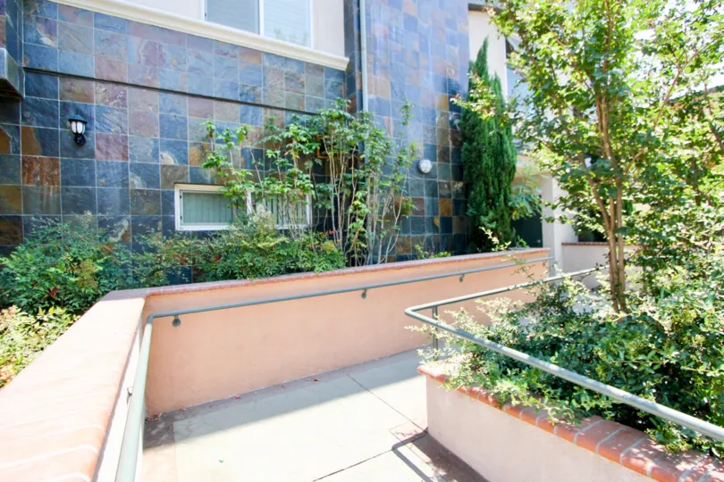 Beautiful multi-colored tile walls with great landscaping and walking paths.