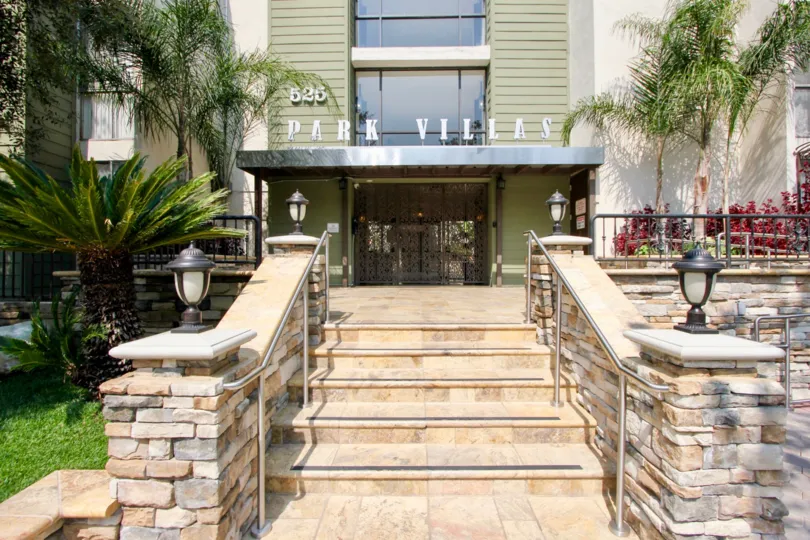 A beautiful walkway surronded by greens leading up to the Park Villas in koreatown, CA