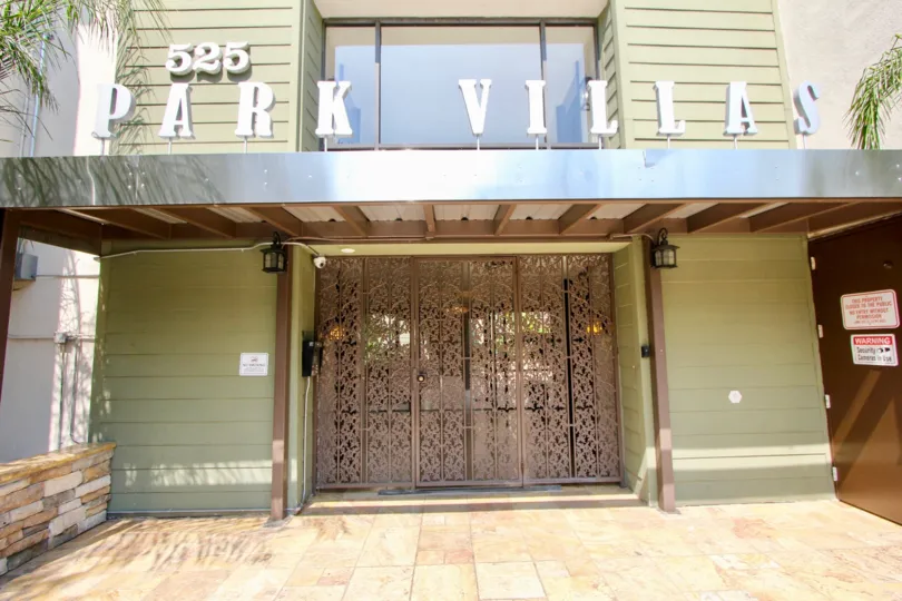 Front entrance at Park Villas with beautifully designed doors and a big Park Villas sign and big window.