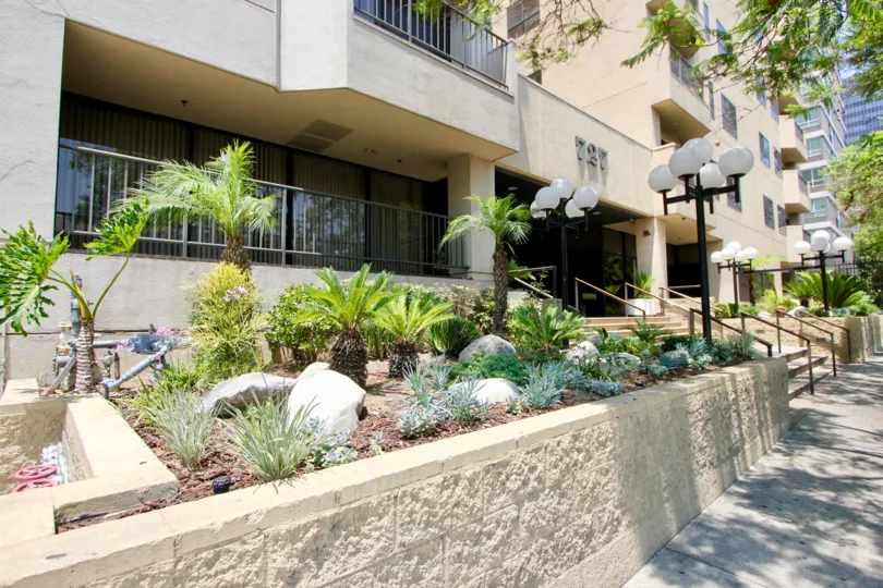 This property shows steps to the entrance with lamps to light the way of the landscaped planting beds and walkway.