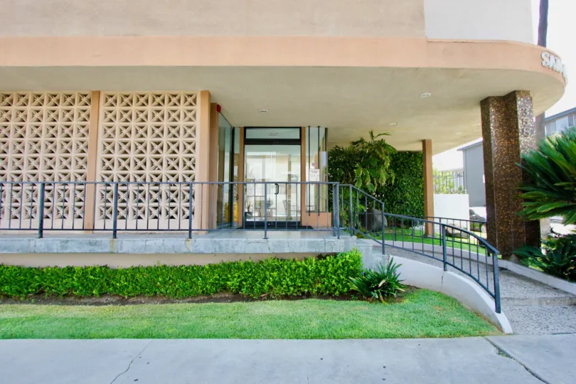 A good view in the San Marcus with a building front and lawn.