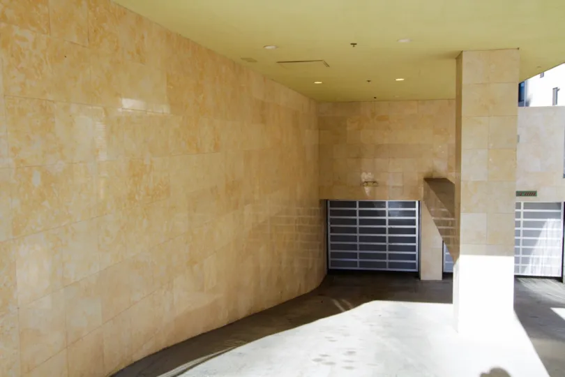 The entrance to the garage area of Serrano Palace is covered in travertine tiles
