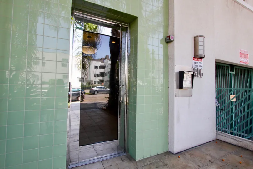 A see-through door in the serrano towers community. The tiles around teh door seem to be newly painted.