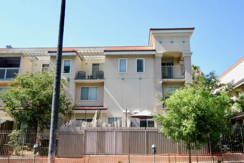 Shatto Villas boasts a gate surrounding the property and three stories of units with balconies.