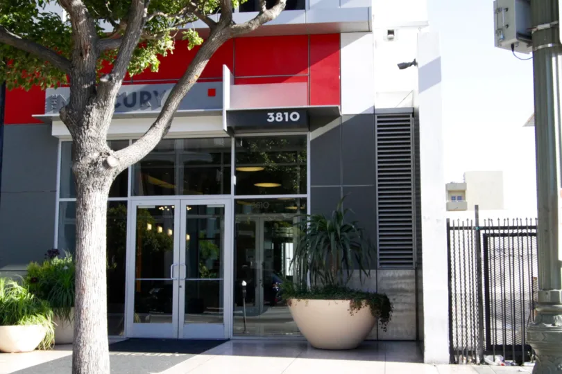 A glass door leads to the lobby of The Mercury