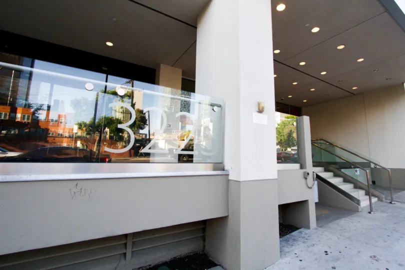Address numbers for The Summit on Sixth are affixed to a glass balcony on the ground floor