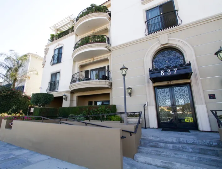 A wheelchair ramps zigzags to the front entrance to Wilshire Park Villa