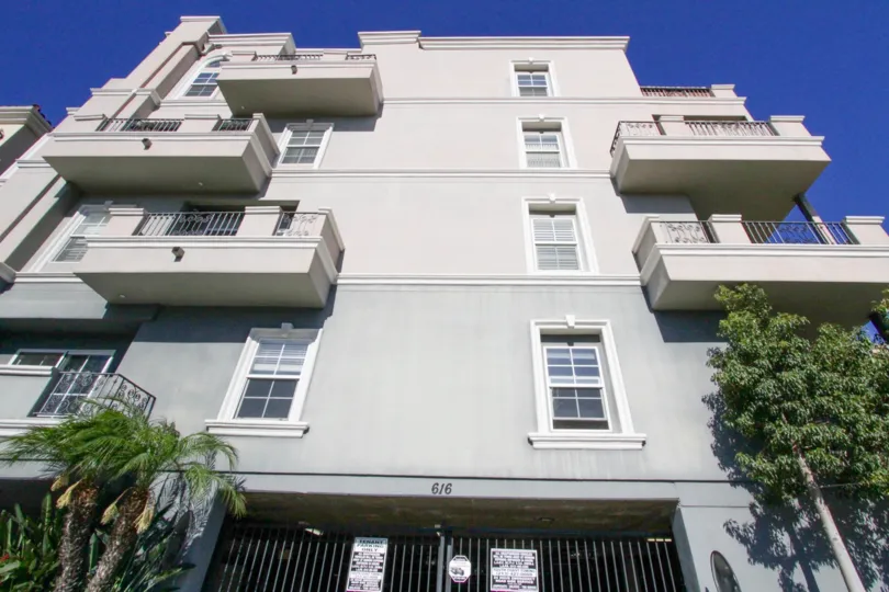 Balconies extend over the front of Wilton Manor staggered at the center and around the corner of the building